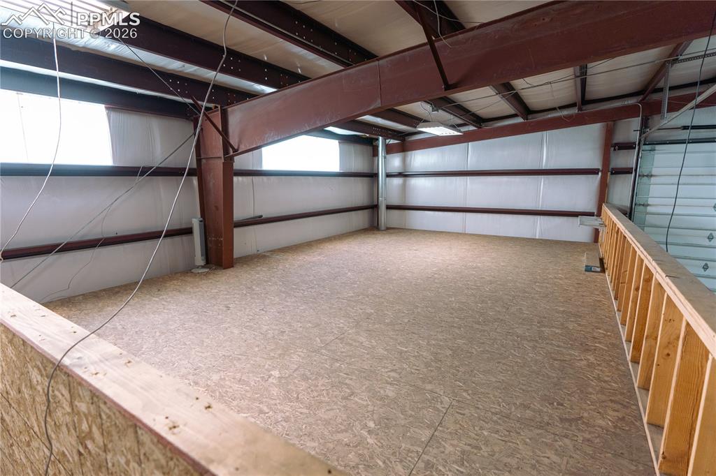 Image 28 of 42: Spacious interior with an unfinished open floor plan, featuring exposed met