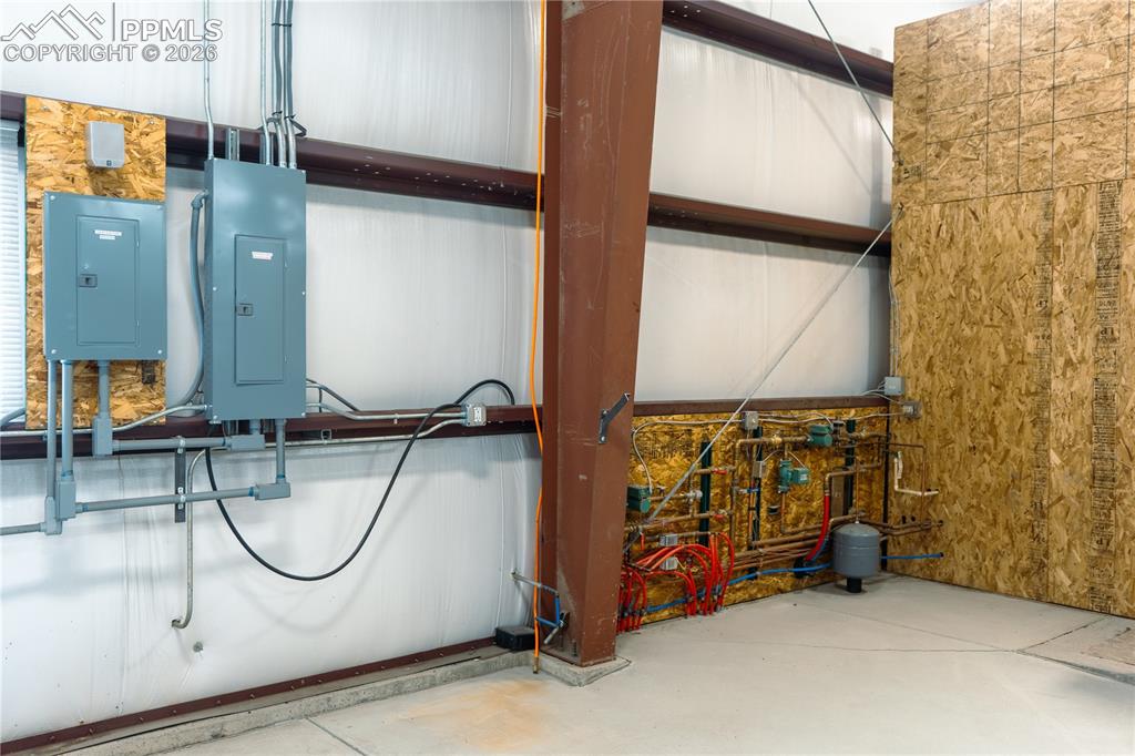Image 30 of 42: The property features robust structural beams and a concrete floor