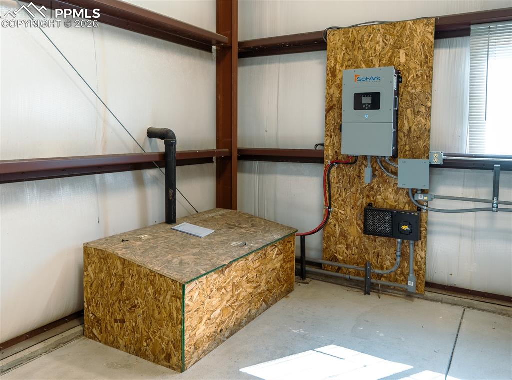 Image 31 of 43: The property includes structural steel beams, a white corrugated metal wall