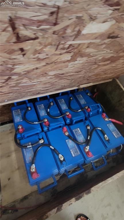 Image 32 of 43: The property includes a system of blue batteries with red and black termina
