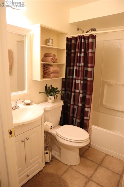 Image 31 of 34: Full bathroom featuring vanity, light tile patterned flooring, and shower /