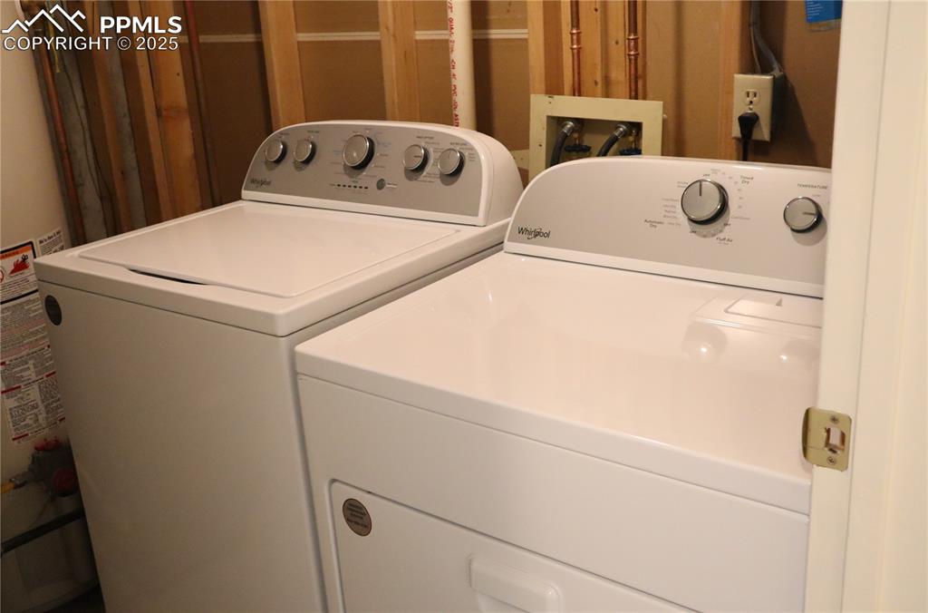 Image 32 of 34: Laundry room featuring new washer and clothes dryer