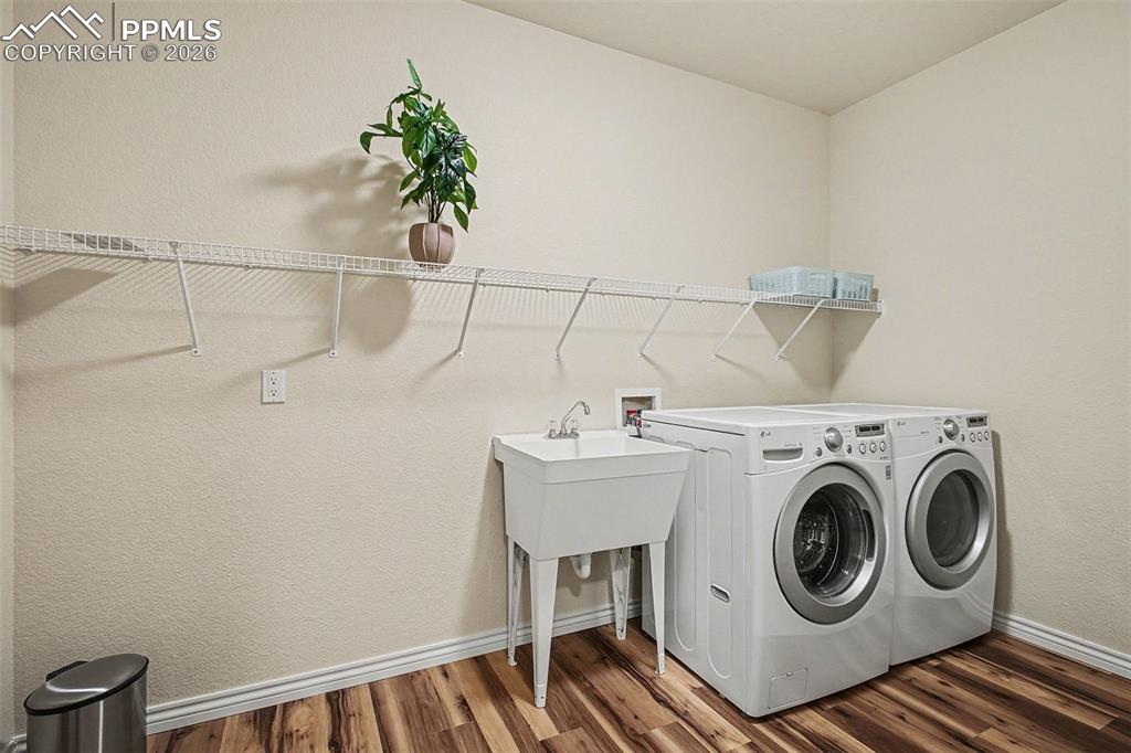 Image 38 of 45: Large laundry room with sink and storage