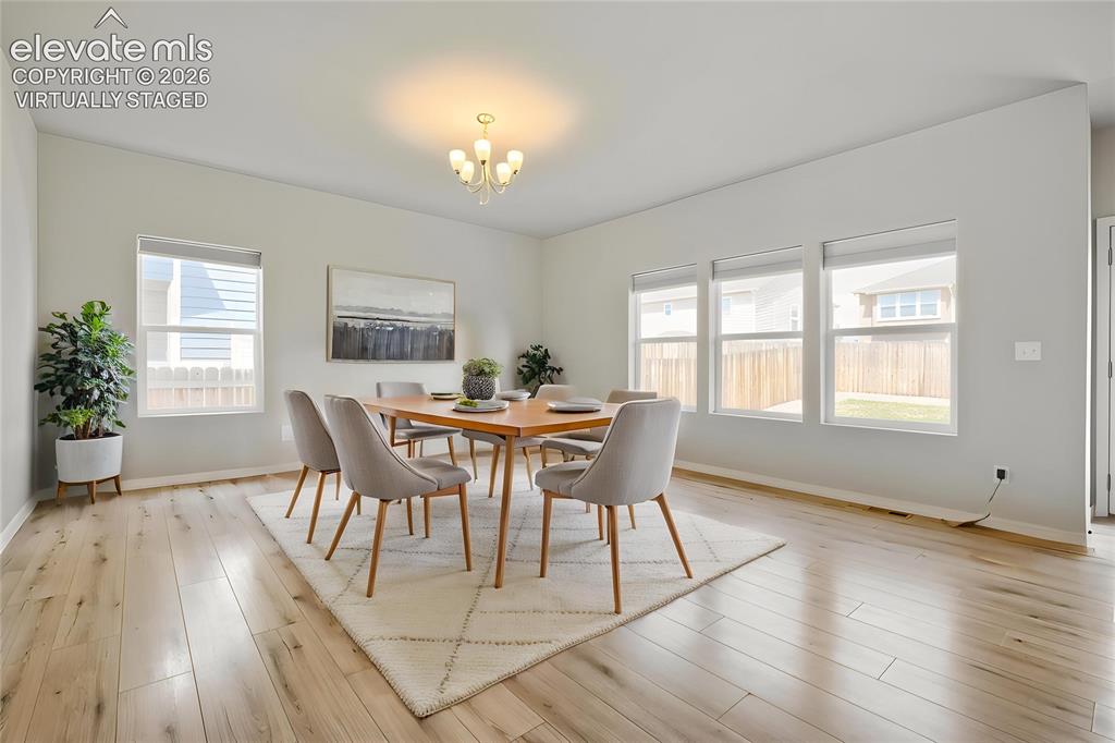 Image 13 of 33: Virtually Staged Spacious interior featuring light wood-finish flooring, mu