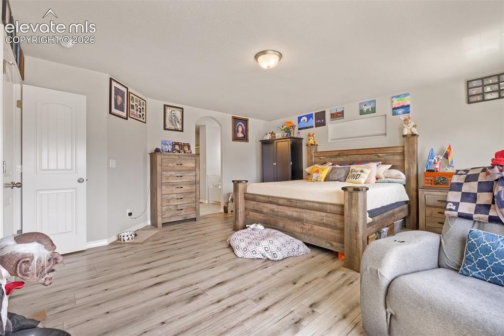 Image 15 of 32: Light wood-finish flooring throughout, complemented by a muted wall palette