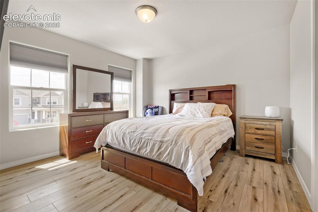 Image 18 of 33: Bright interior space featuring light wood-finish flooring, neutral wall to