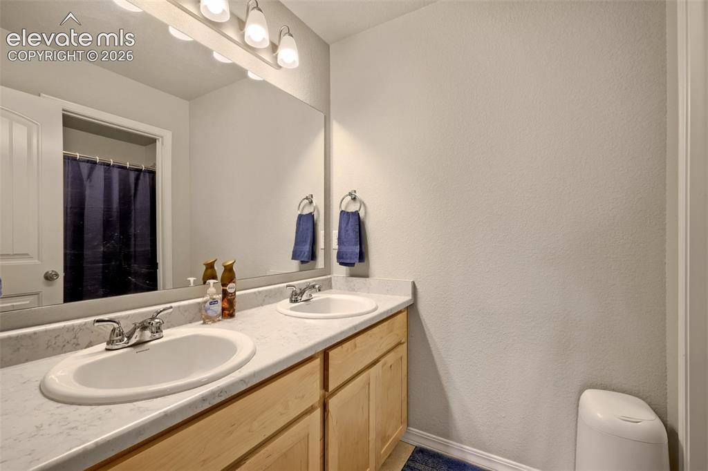 Image 20 of 33: Bathroom featuring a dual sink vanity with integrated oval basins and chrom