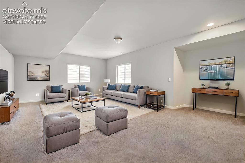 Image 25 of 33: Virtually Staged Spacious room featuring light gray wall paint, recessed li