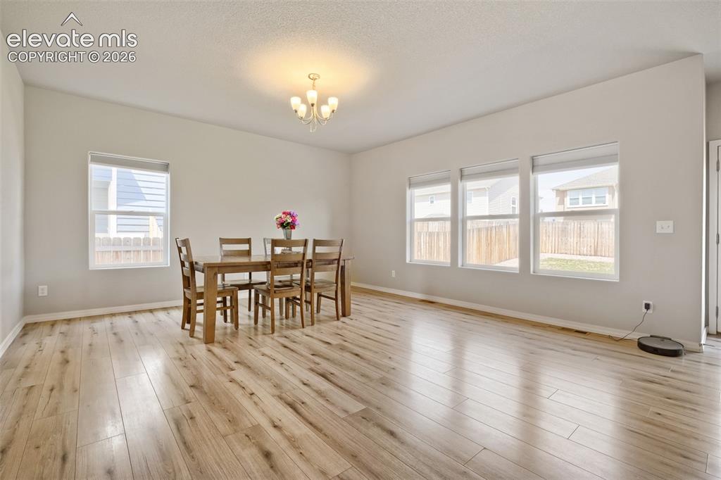 Image 9 of 32: Kitchen featuring wood-finish flooring, a central island with an undermount