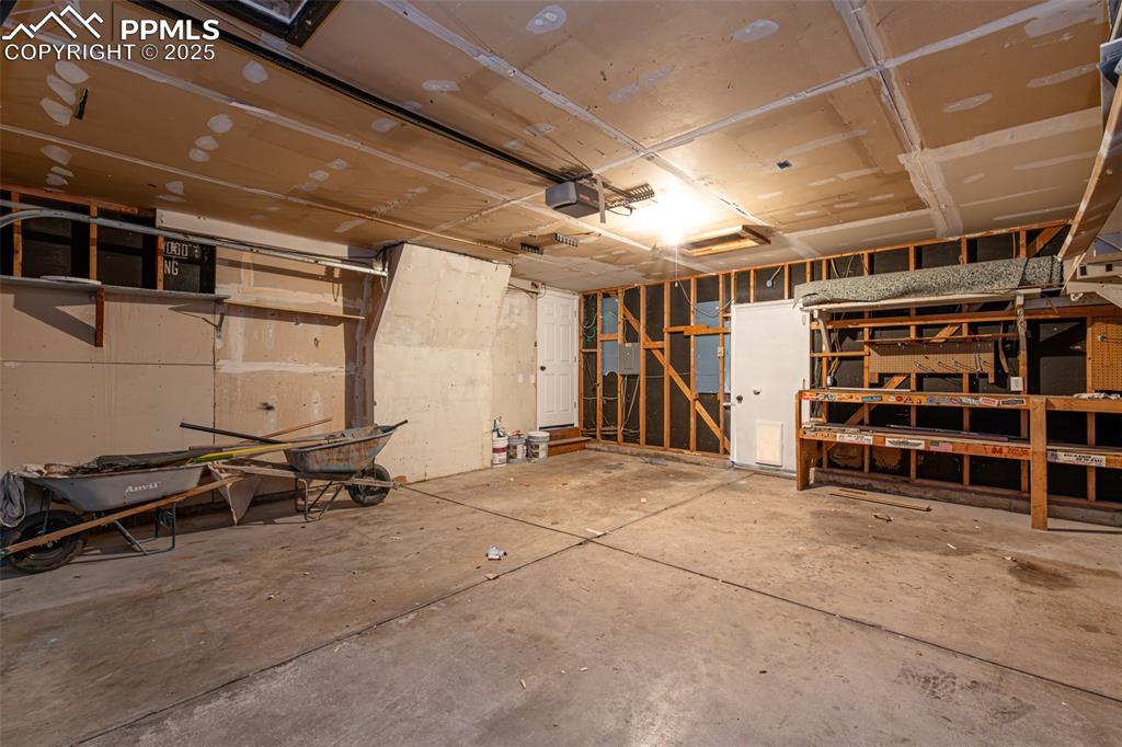 Image 33 of 33: Garage with a garage door opener