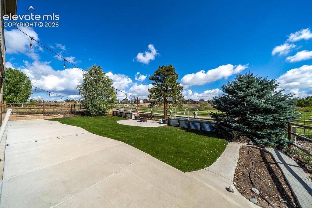 Image 11 of 50: Expansive concrete patio with integrated artificial turf