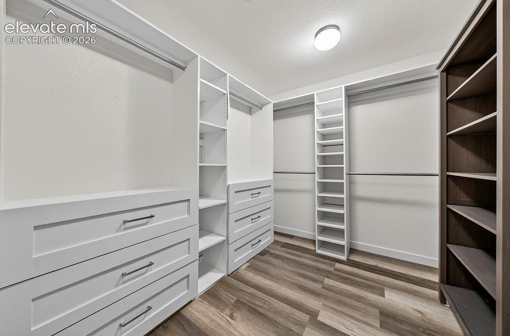 Image 27 of 50: Custom closet organization system featuring built-in drawers with modern pu