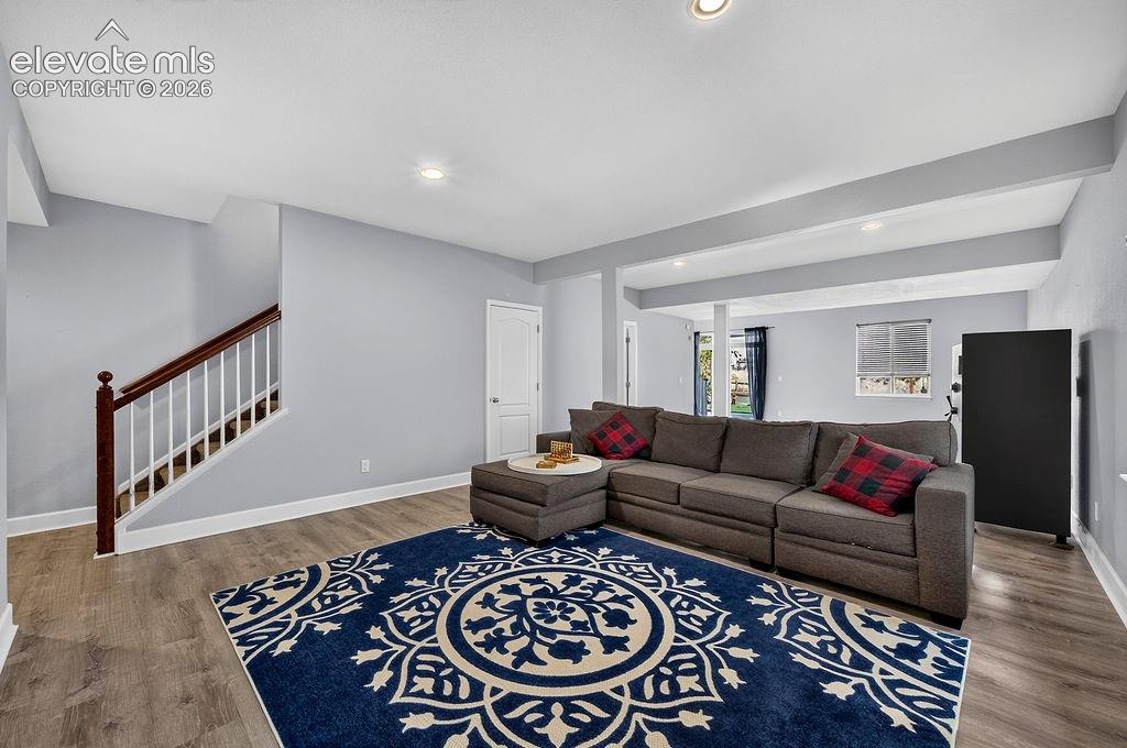 Image 38 of 50: Wood-finish flooring throughout, recessed lighting, white trim, and a white