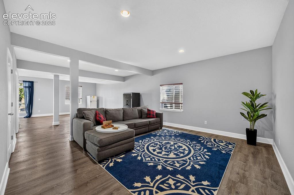 Image 39 of 50: Recessed lighting illuminates the open-concept living space, featuring wood