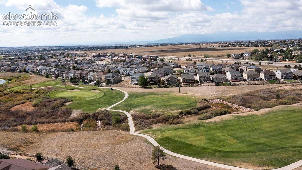 Image 4 of 50: Expansive golf course with manicured greens and walking paths, surrounded b