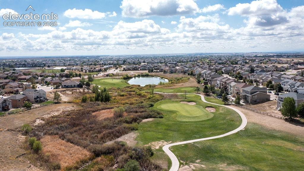 Image 6 of 50: Expansive golf course setting featuring manicured greens, a golf cart path,