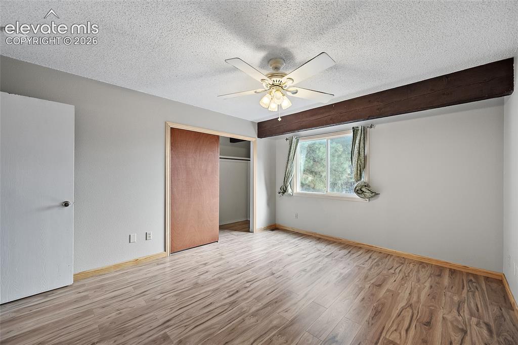 Image 10 of 29: Fireplace with tile surround and wood mantel
