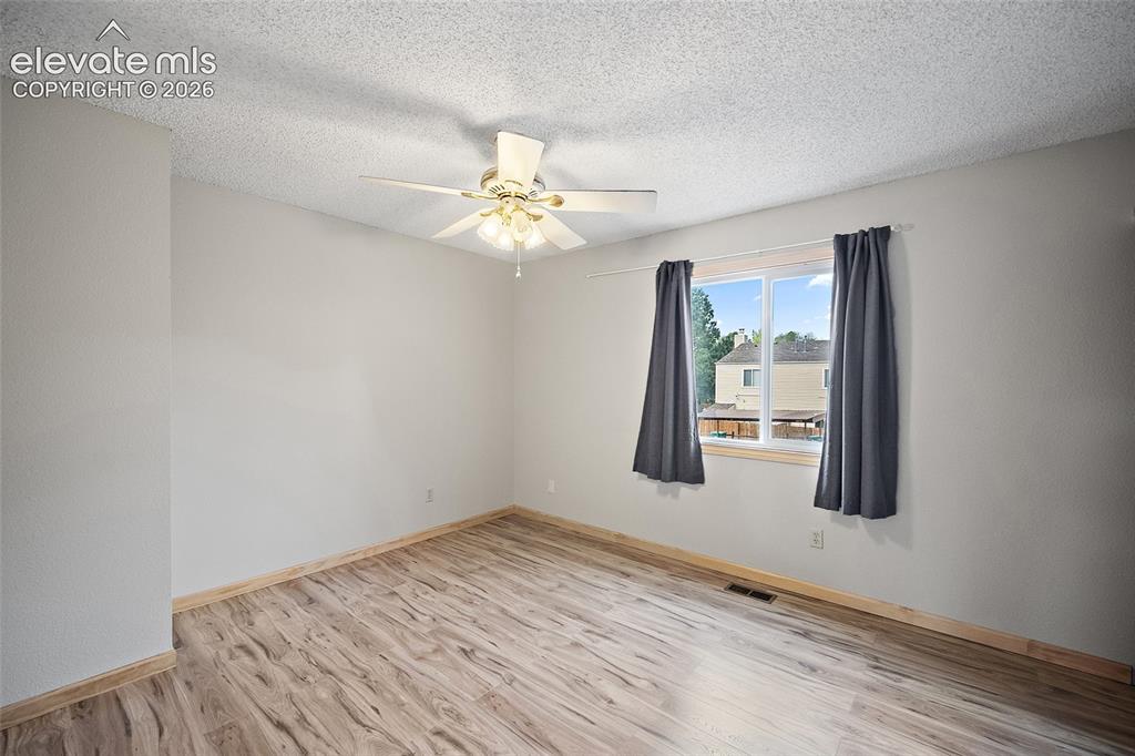 Image 13 of 29: Wood-finish flooring, ample wood cabinetry, stainless steel appliances, and