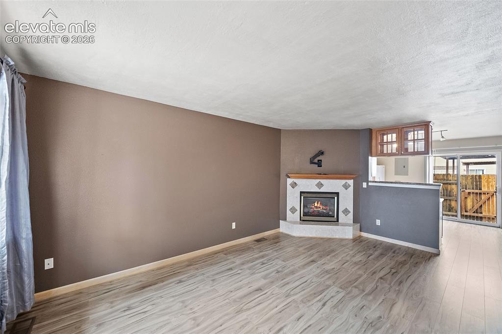 Image 14 of 29: Wood-finish flooring, ceiling fan with integrated lighting, exposed beam ac
