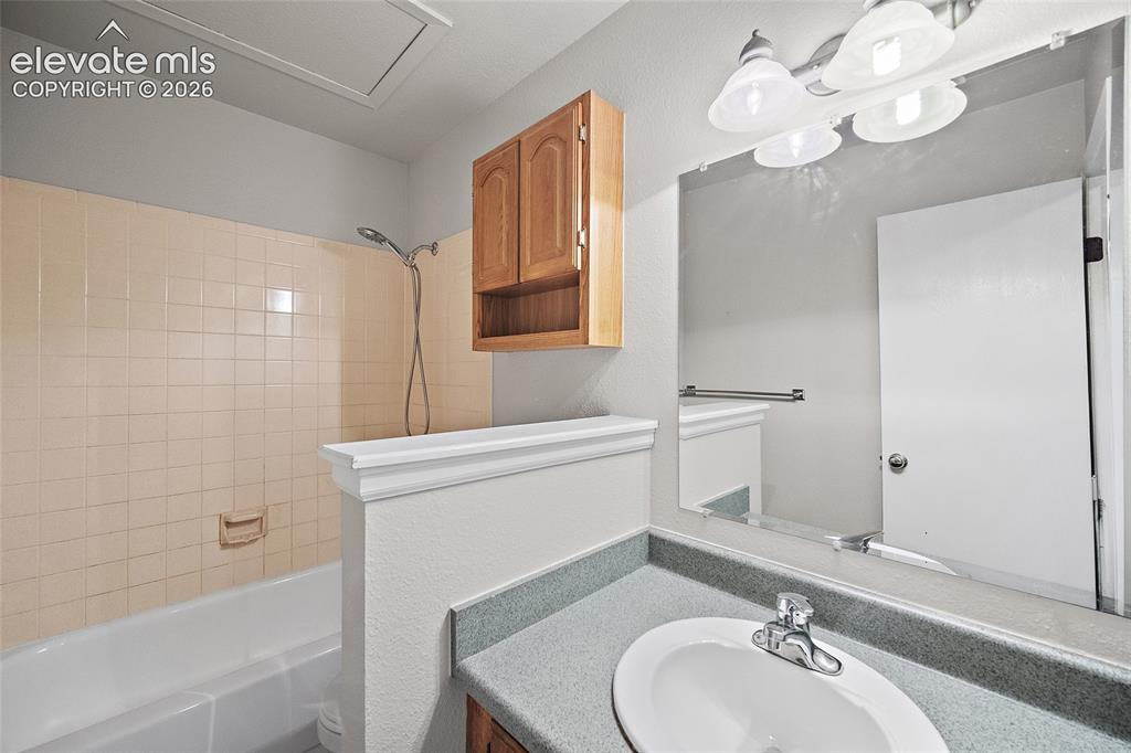 Image 15 of 29: Wood-finish flooring, ceiling fan with integrated lighting, and a window pr