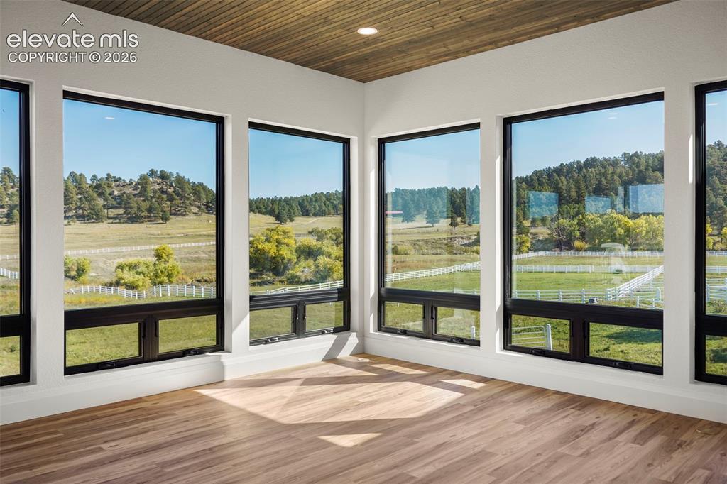 Image 15 of 41: Wood-finish flooring, white walls, and a wood-paneled ceiling