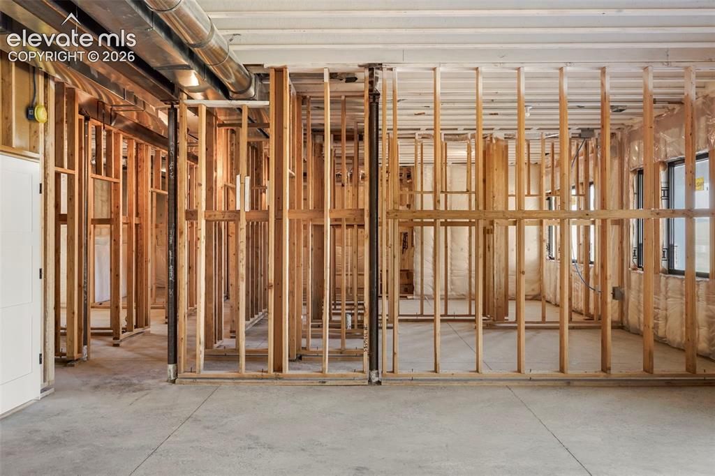Image 17 of 41: Exposed wood framing with concrete flooring, visible ductwork, and multiple