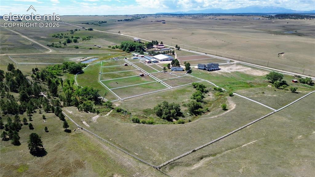 Image 2 of 41: Expansive property featuring multiple fenced paddocks, several outbuildings