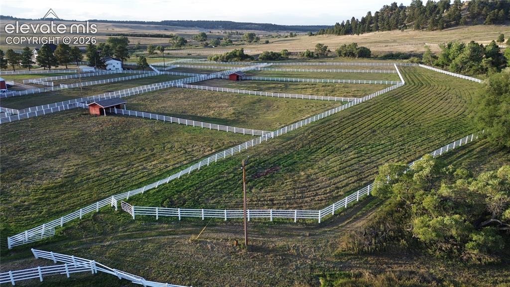 Image 26 of 41: Expansive land parcel featuring multiple fenced enclosures, rolling terrain
