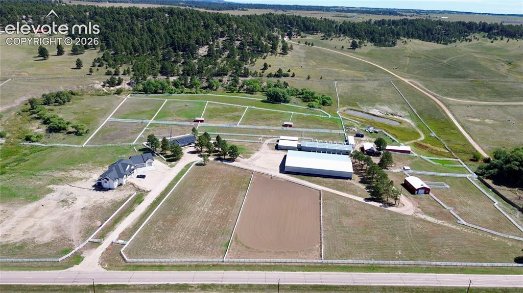 Image 3 of 41: Expansive property featuring multiple outbuildings, fenced paddocks, a larg