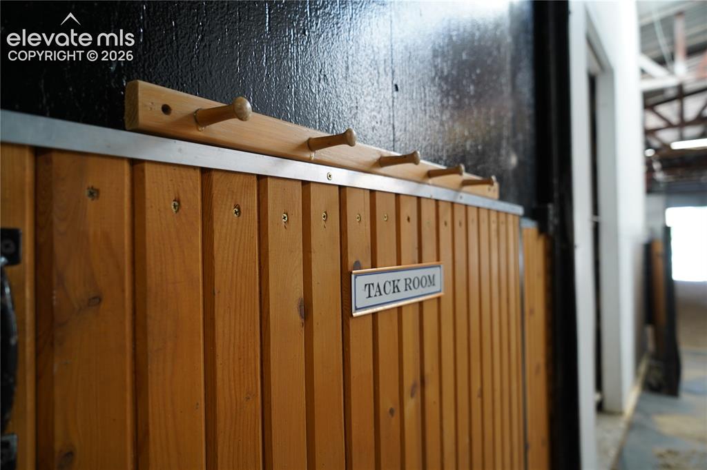 Image 32 of 41: Wood-paneled room with a "Tack Room" sign