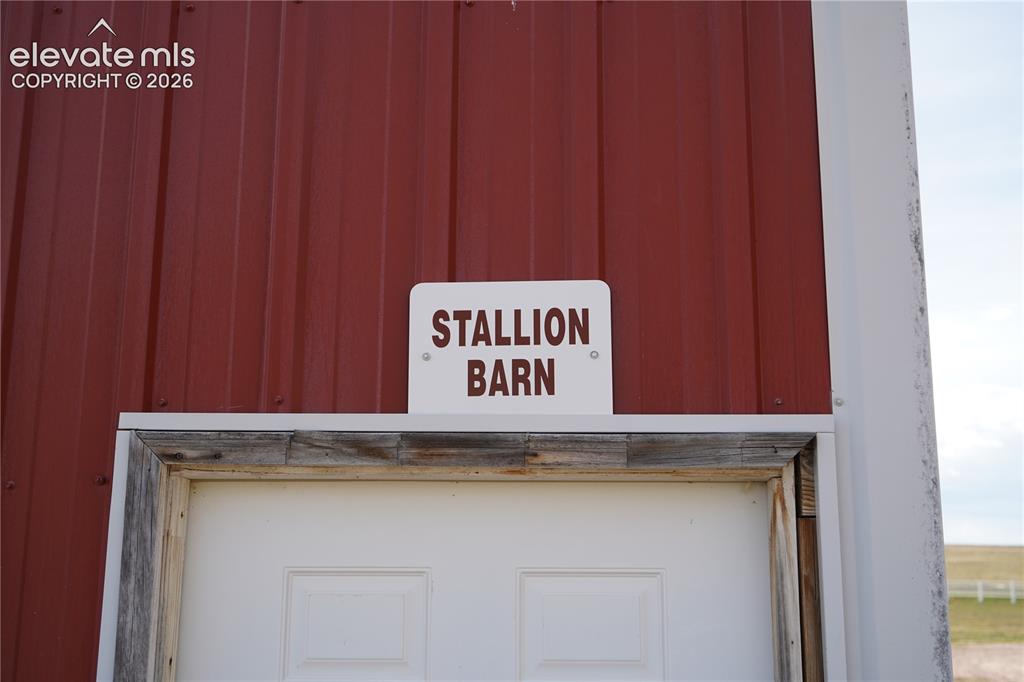 Image 35 of 41: Red corrugated metal siding with white trim