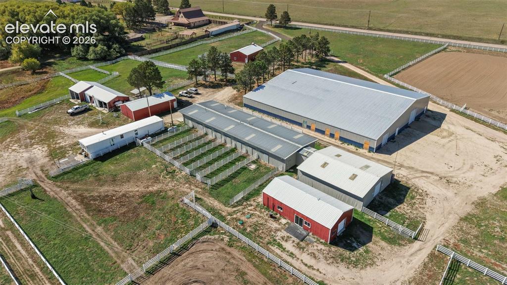 Image 4 of 41: Expansive acreage featuring multiple outbuildings, fenced enclosures, large