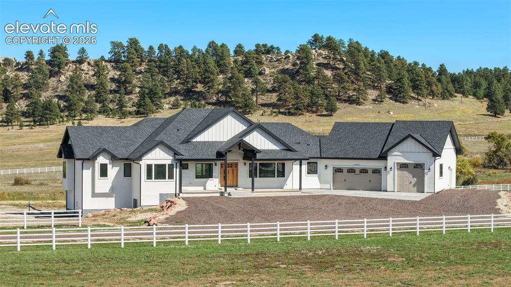 Image 6 of 41: Contemporary farmhouse exterior with white siding and dark trim