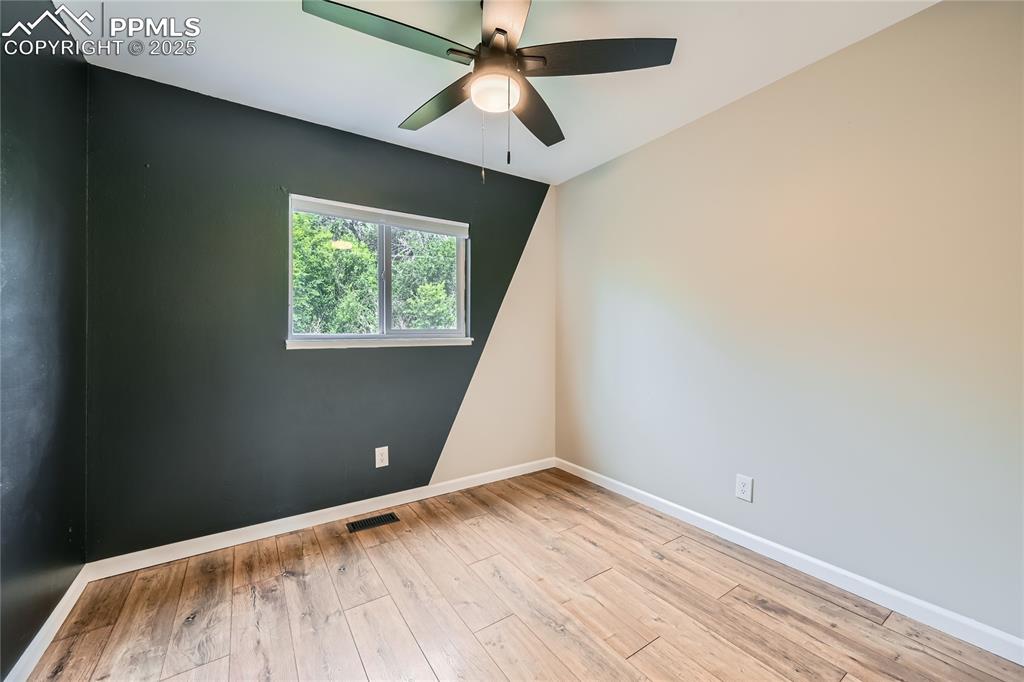Image 16 of 32: Empty room featuring ceiling fan and hardwood / wood-style floors