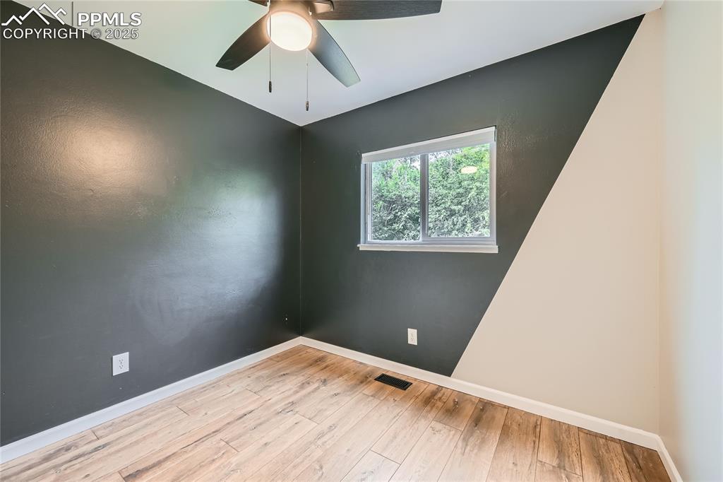 Image 18 of 32: Empty room featuring hardwood / wood-style flooring and a ceiling fan