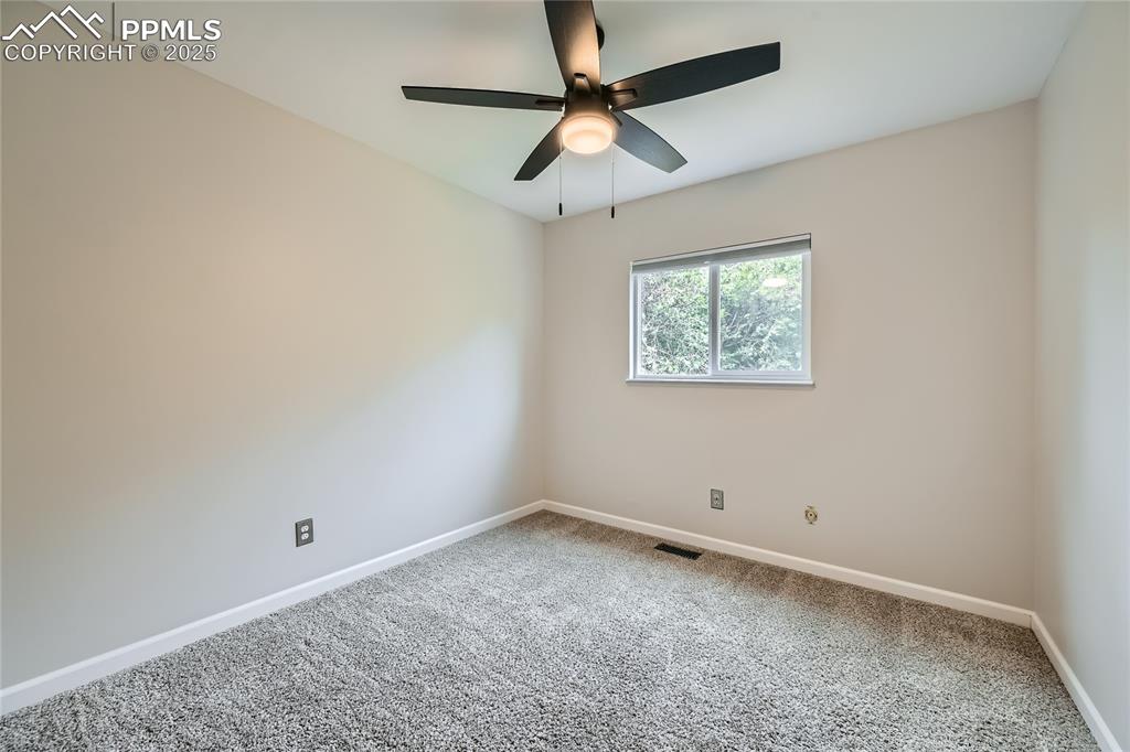 Image 19 of 32: Spare room with carpet floors and a ceiling fan