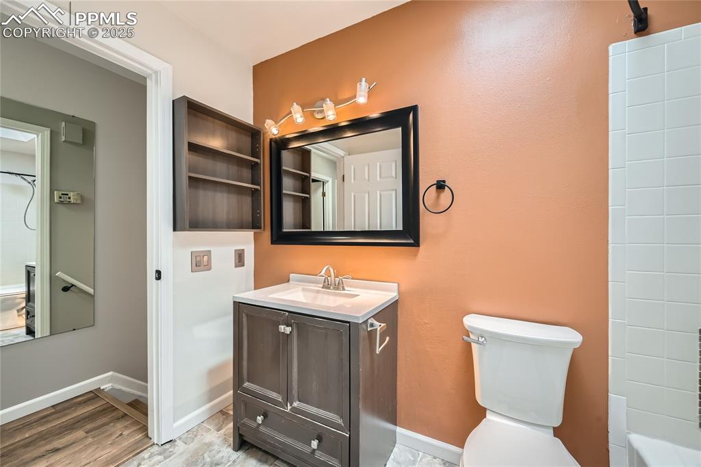 Image 21 of 32: Full bath with vanity, wood finished floors, and shower / tub combination