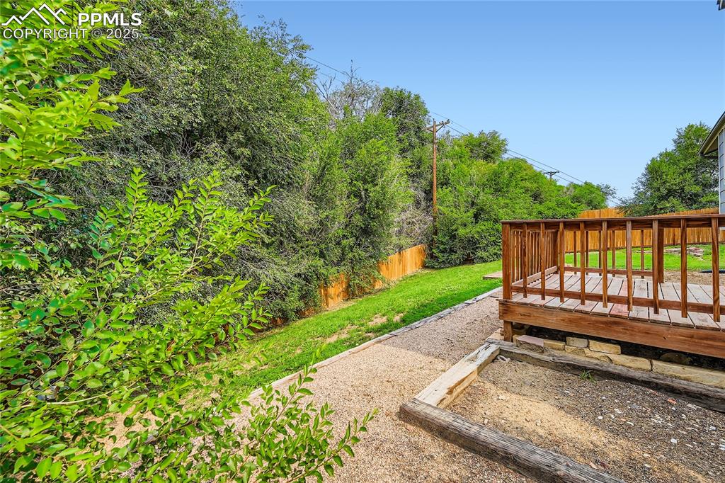 Image 26 of 32: View of yard featuring a wooden deck