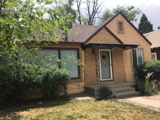 Caption: Brick and stucco exterior with a covered entry