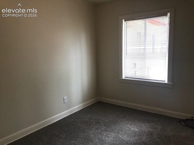 Image 11 of 18: Neutral paint tones with an electrical outlet, accompanied by a window with