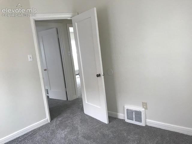 Image 12 of 18: Neutral wall paint with crisp white trim, featuring plush carpeting and a w