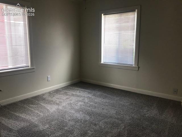 Image 13 of 18: Plush gray carpet flooring, neutral wall paint, and two windows with blinds