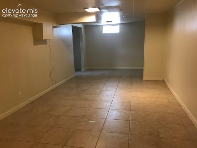 Image 15 of 18: Spacious room featuring neutral-toned tile flooring, light-colored walls, a