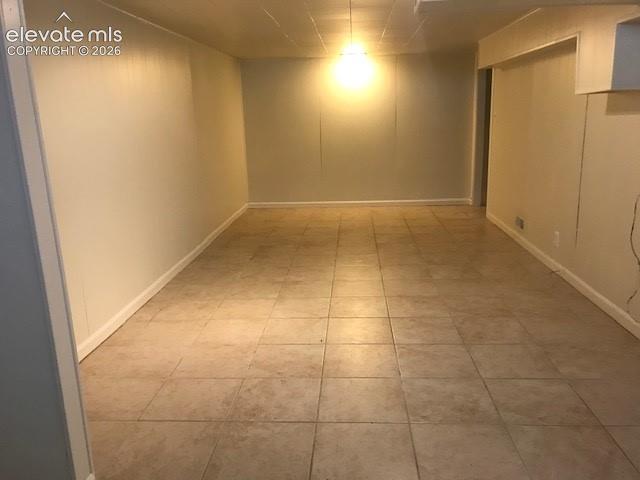 Image 16 of 18: Tile flooring with light-toned walls and a drop ceiling