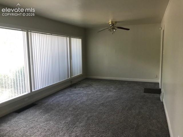 Image 3 of 18: Wall-to-wall gray carpeting, white painted walls, ceiling fan with integrat