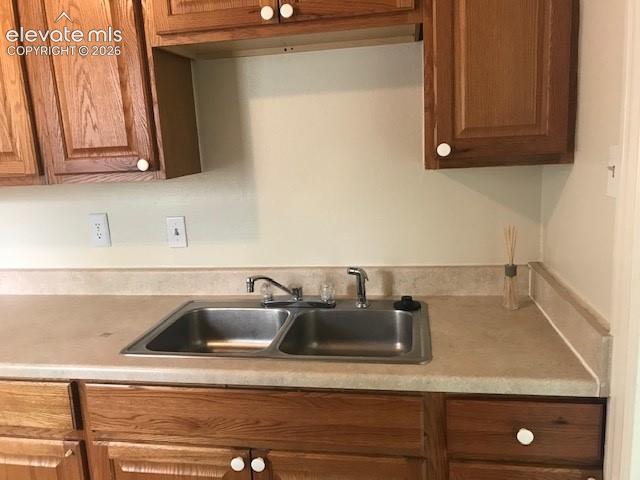 Image 5 of 18: Dual basin stainless steel sink with chrome faucet, light-toned countertop,