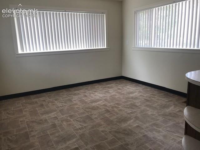 Image 6 of 18: Vinyl plank flooring, white vertical window blinds, and a built-in counter