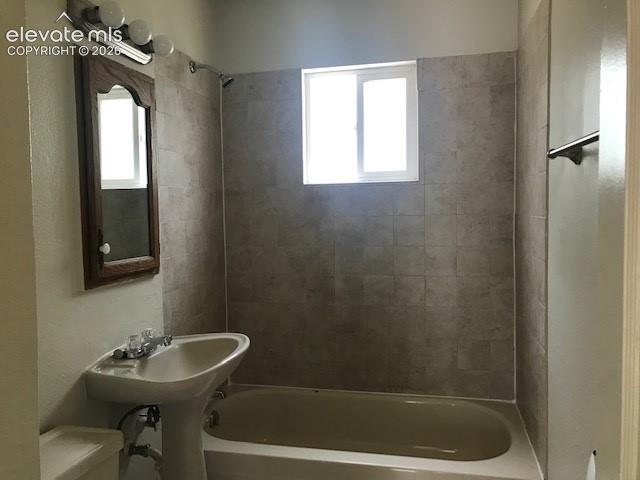Image 9 of 18: Pedestal sink with chrome faucet, framed mirror, and vanity lighting
