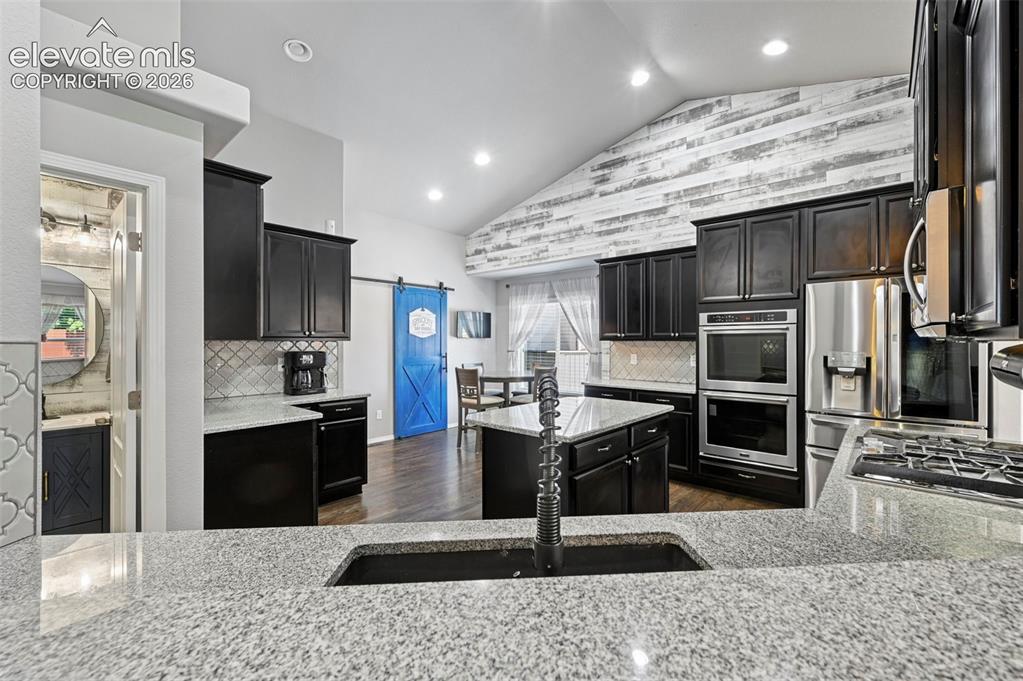 Image 10 of 50: Stunning designer gourmet kitchen w/ double ovens, coffee bar, stainless ap