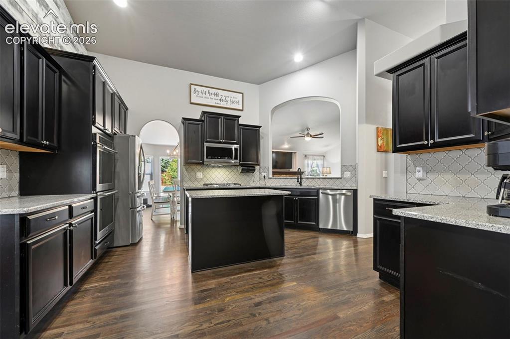 Image 11 of 50: Stunning designer gourmet kitchen w/ double ovens, coffee bar, stainless ap